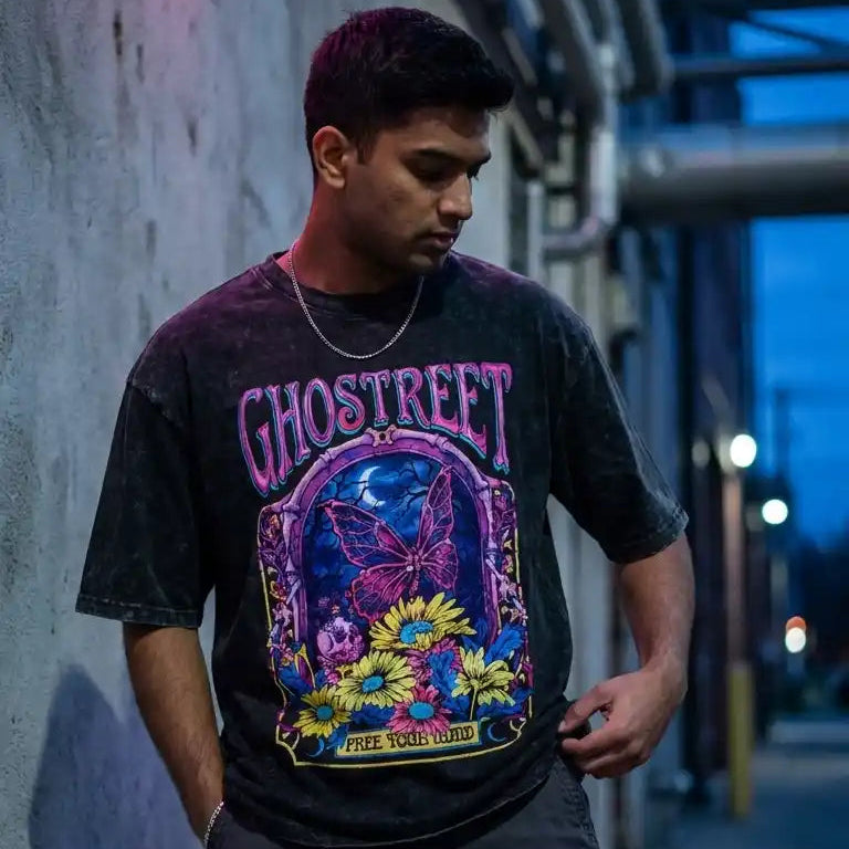 Ghostreet Vintage Black Acid Wash Oversized T-Shirt with Psychedelic Butterfly and Floral Graphic male model rode side neon board