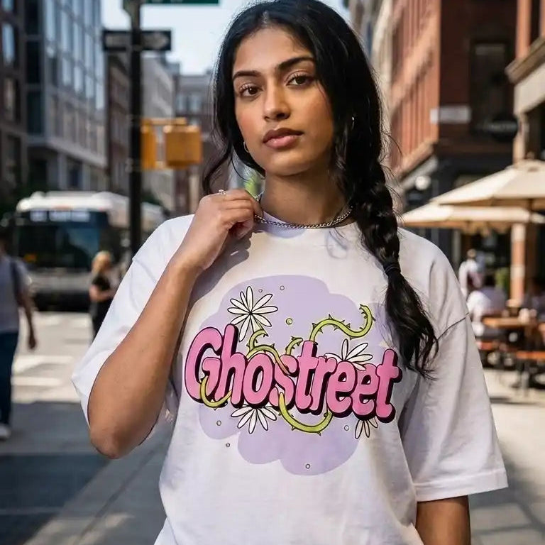 Female model wearing Ghostreet white drop-shoulder floral graphic t-shirt styled with dark cargos and silver chain